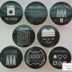 May include: Set of ten round black and white laundry themed magnets with various designs and text. The magnets feature a washing machine, clothes pegs, laundry symbols, and the words "Laundry", "Wash", "Dry", "Fold", "Repeat", "Clean", "Bleach", "Good", "Fun", and "Laundry Room".