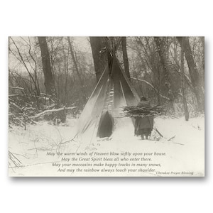 May include: A black and white photograph of a Native American person carrying firewood towards a teepee in a snowy forest. The image includes a quote from a Cherokee prayer blessing: "May the warm winds of Heaven blow softly upon your house. May the Great Spirit bless all who enter there. May your moccasins make happy tracks in many snows, And may the rainbow always touch your shoulder. Cherokee Prayer Blessing"