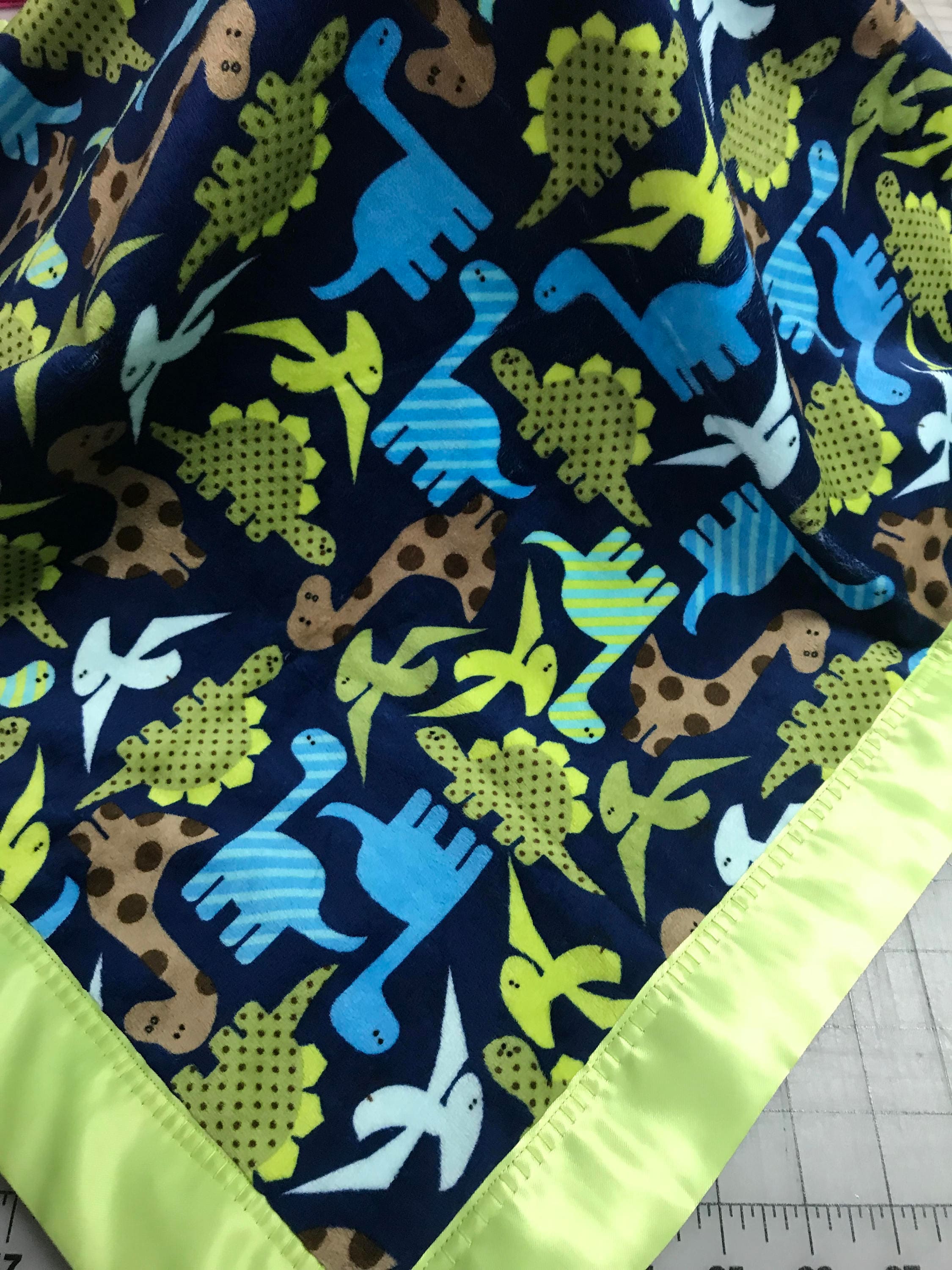 Dinosaur minky baby blanket with royal satin backing and lime binding