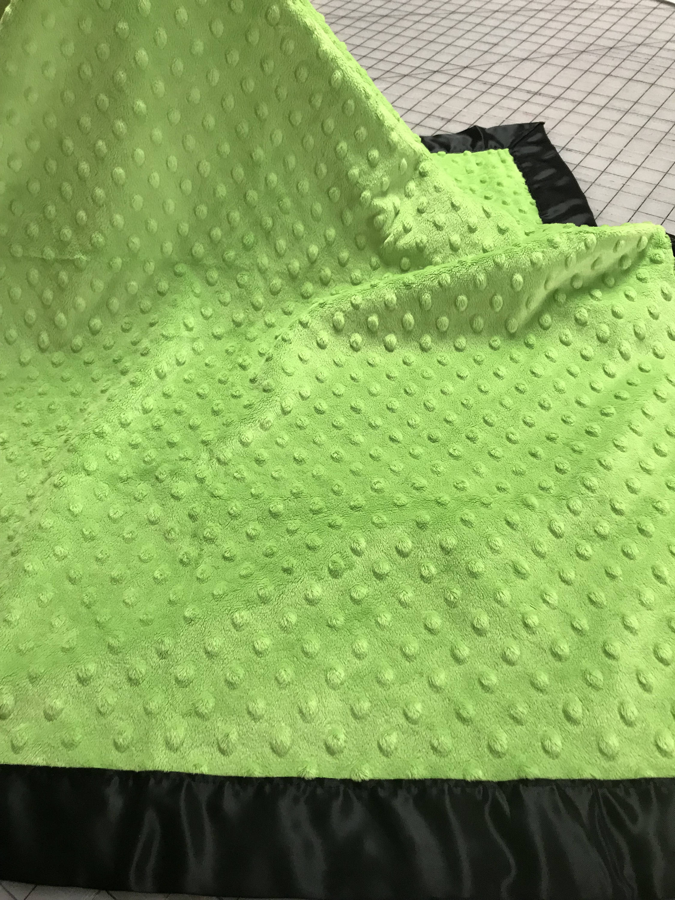 Lime minky dot blanket with black satin and binding