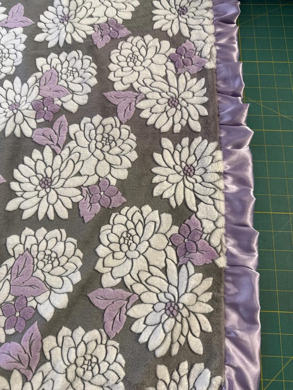 Lavender and grey floral 30 x 35 minky and satin baby blanket with ruffles.