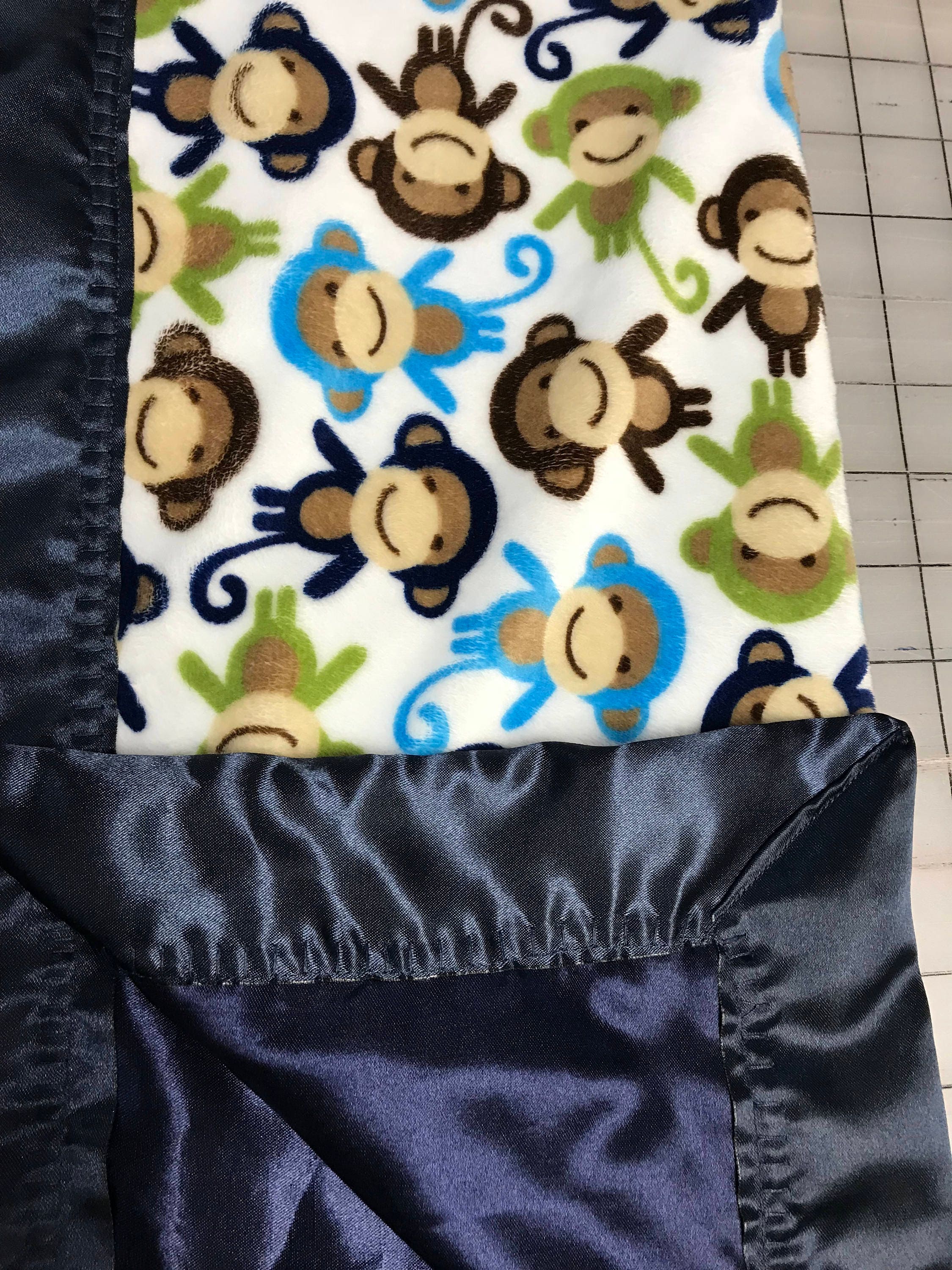 Monkeys all around minky baby blanket with navy satin backing and binding