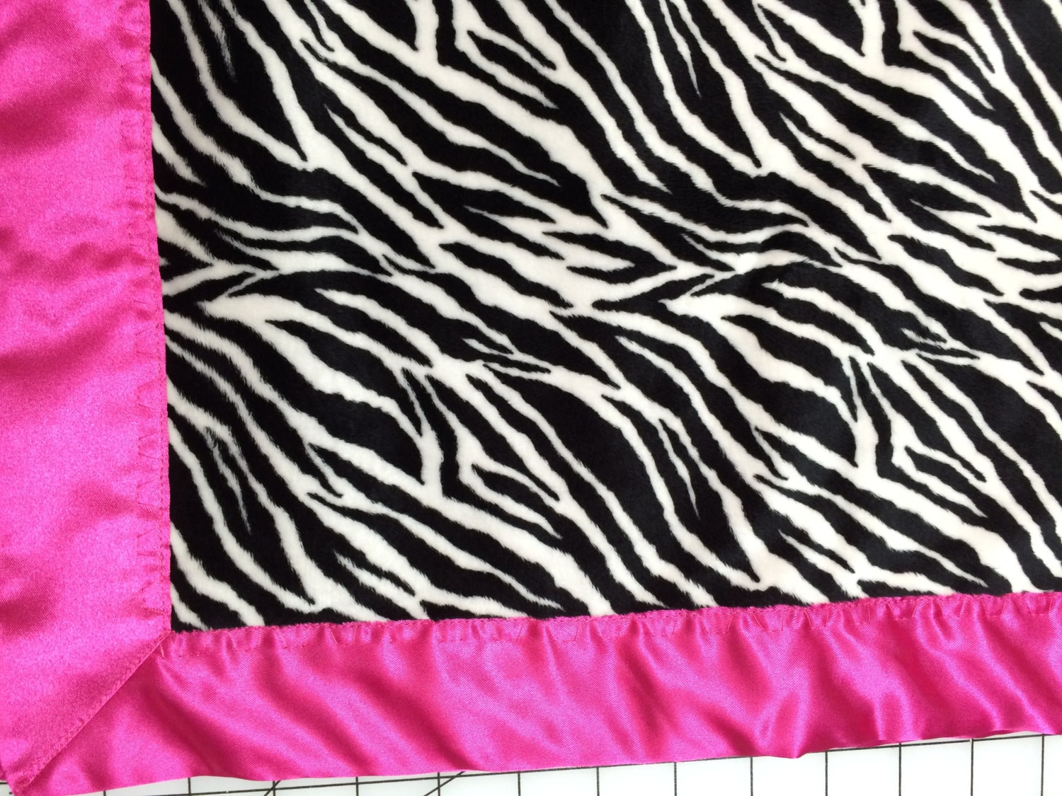 30 x 35 zebra stripe minky blanket with hot pink satin backing and binding