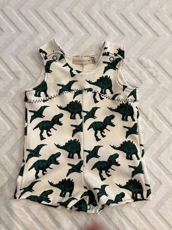 Dinosaur romper with Dino tracks detailing