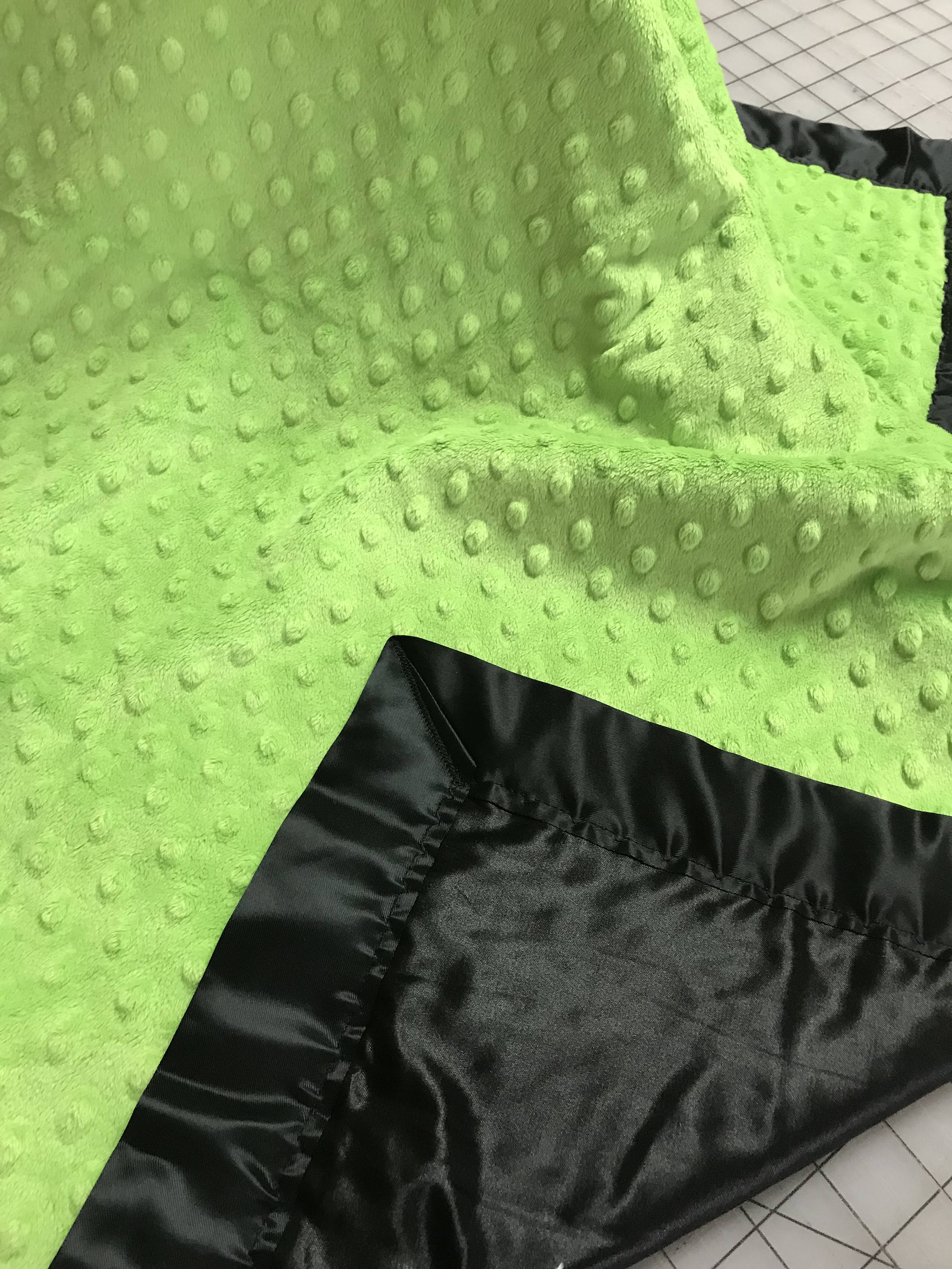 Lime minky dot blanket with black satin and binding