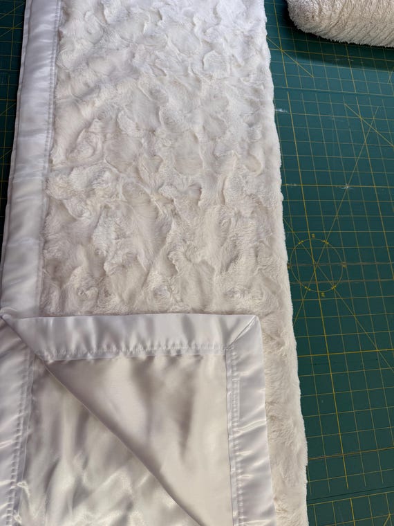 30 x 35 white/ off white textured minky blanket with white satin backing and binding and Free embroidery.