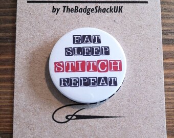 Może przedstawiać: Okrągły, biały magnes na igły z czarnym tekstem, który brzmi "Eat Sleep Stitch Repeat". Tekst "Stitch" jest czerwony. Magnes na igły znajduje się na brązowej kartce z tekstem "Needle Minder by TheBadgeShackUK" i "www.etsy.com/shop/TheBadgeShackUK".