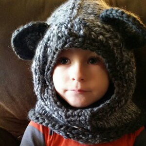 Baby bear cowl in stormy skies with slate grey accent & oversized coconut button.  Size 12 - 18 months