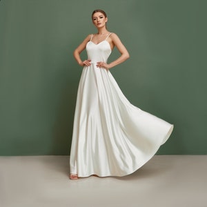 White minimalist wedding dress. Fit and flare skirt dress made from thick silk. Satin fabric is great for this simple wedding outfit.