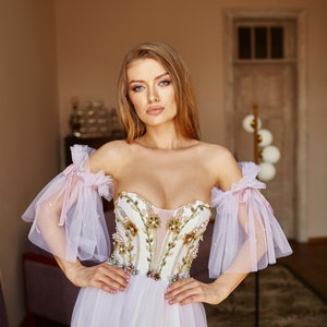 bohemian wedding dress with detachable sleeves and V-shape corset.
Purple Ombre Color. Fit and flare skirt.
Floral embroidery on bodice.
Perfect choice for boho wedding dress, alternative bride or prom dress.