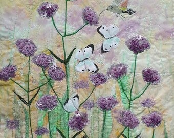 Verbena with hummingbird moth. Garden flowers. Butterflies and moths