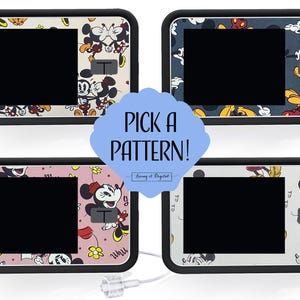 May include: Four insulin pump covers featuring Mickey Mouse designs. Each cover has a black border and a large black screen. The patterns showcase Mickey and Minnie Mouse on cream, navy, pink, and white backgrounds. The text "PICK A PATTERN!" is in a blue bubble.
