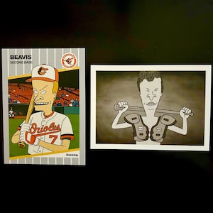 May include: Two cartoon images. One is a baseball card featuring a character in an Orioles uniform, holding a bat. The card reads "Beavis Second Base." The other is a black and white image of a character holding a baseball bat.