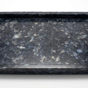 May include: A rectangular tray crafted from dark blue and black stone with a polished finish. The surface features a natural, mottled pattern of deep blue, charcoal, and silver-toned mineral inclusions throughout the entire structure.