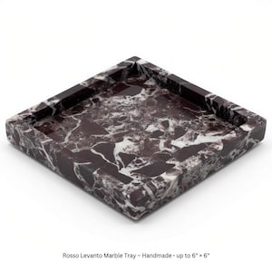 May include: A square Rosso Levanto marble tray featuring a deep burgundy and white veined pattern. The tray has raised edges and a smooth, polished finish. The text on the image reads: Rosso Levanto Marble Tray - Handmade - up to 6" x 6".