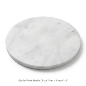 May include: A circular trivet made of glacier white marble with natural grey veining throughout the stone surface. The product is labeled as Glacier White Marble Circle Trivet with available sizes ranging from 6 inches to 12 inches in diameter.