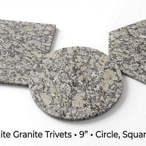 May include: Three Rockville White granite trivets in square, circular, and hexagonal shapes. Each piece features a speckled gray and white stone pattern. The text below reads: Rockville White Granite Trivets • 9” • Circle, Square & Hexagon.