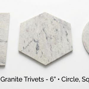 May include: Three Bianco Romano granite trivets in square, hexagonal, and circular shapes. Each piece features a light gray and white speckled stone pattern with natural veining. Text below reads: Bianco Romano Granite Trivets - 6" • Circle, Square & Hexagon.