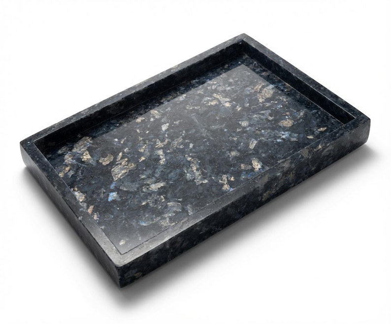 May include: A rectangular tray crafted from dark blue and black stone with a polished finish. The surface features a natural, mottled pattern with iridescent silver and light blue flecks embedded throughout the deep, dark base material.
