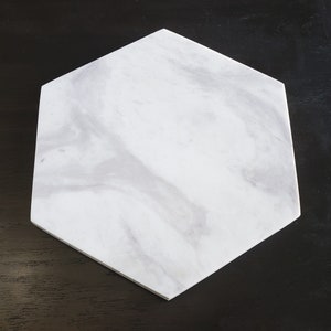 May include: White hexagonal marble serving tray with grey veining.