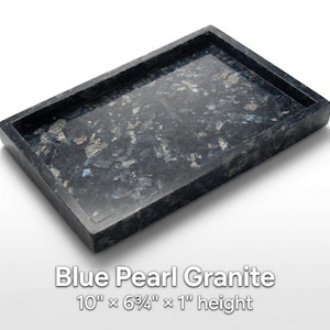 May include: A rectangular tray made of Blue Pearl granite with a polished surface featuring dark blue, black, and shimmering silver-grey mineral flecks. The tray measures 10 inches by 6.75 inches by 1 inch in height as stated in the text.