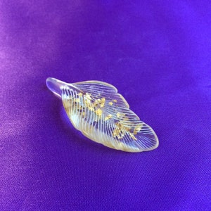 Handmade feather containing crystals and 22carat gold leaf