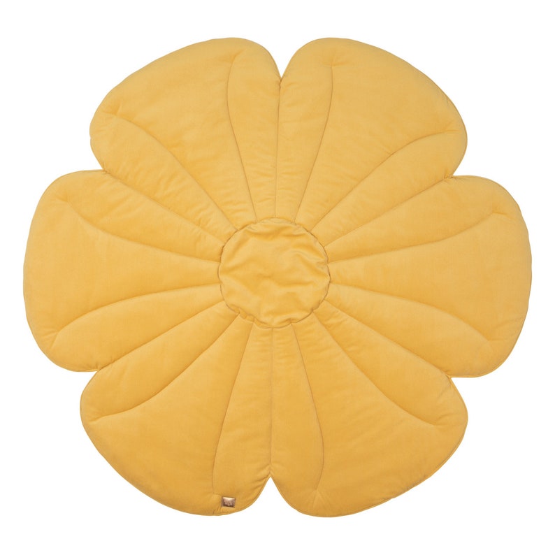 May include: A yellow flower-shaped play mat with a quilted texture. The mat is made of soft fabric and is ideal for babies and toddlers to play on.