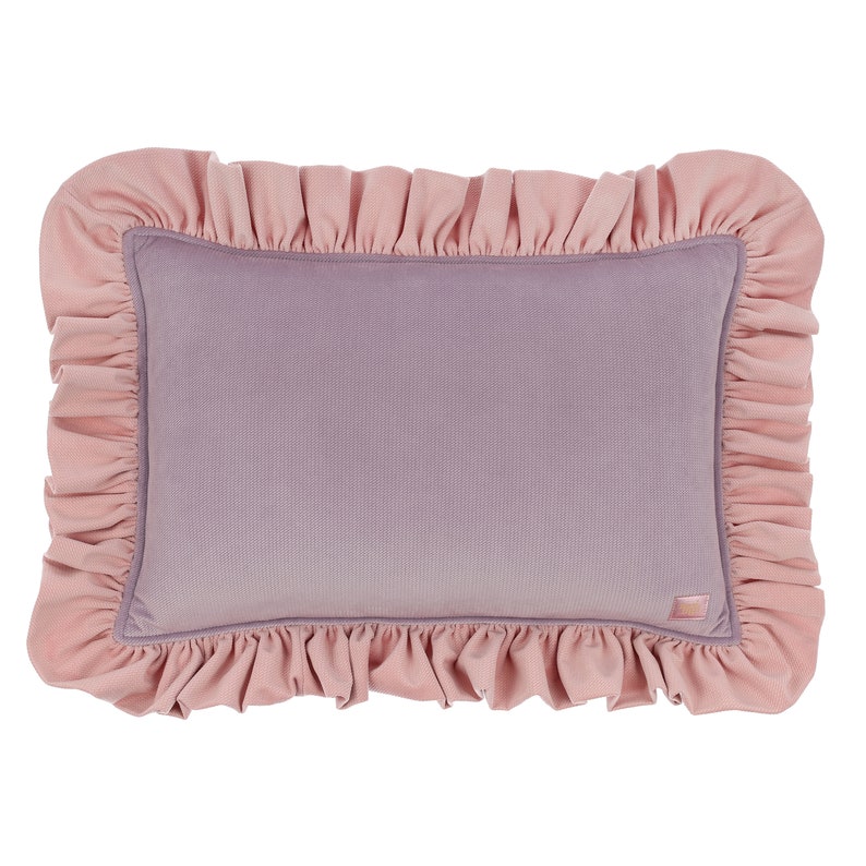 May include: A pink and purple decorative cushion with a ruffled edge.