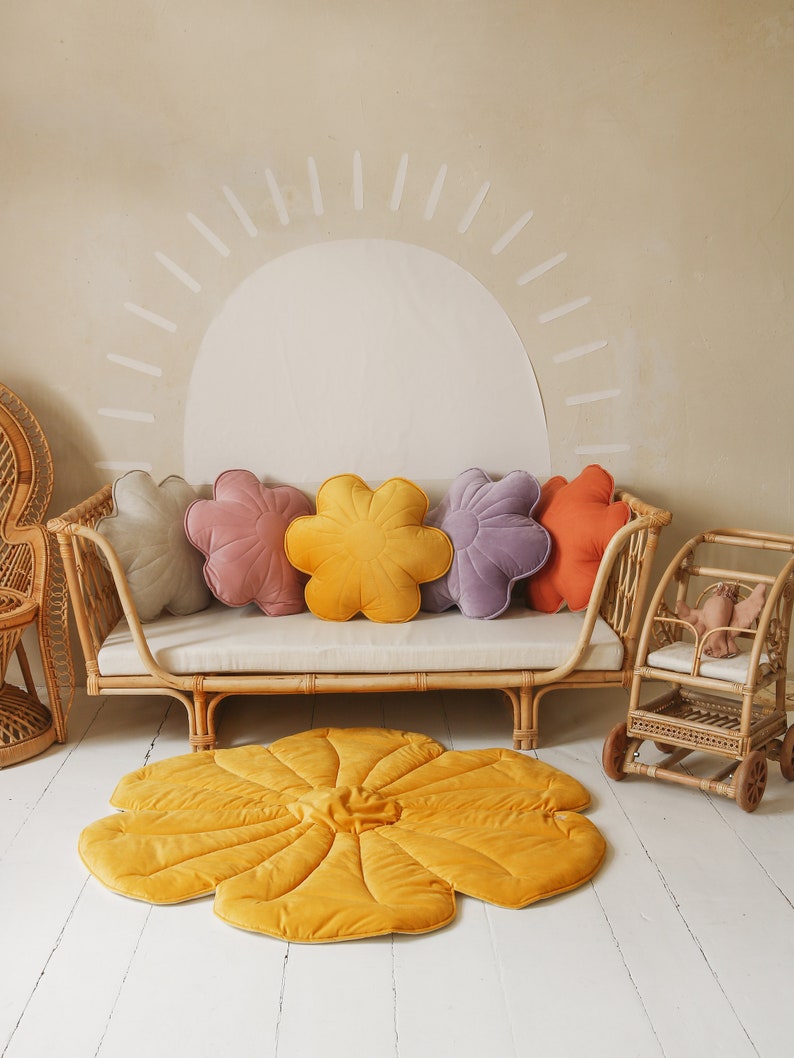 May include: A yellow flower-shaped play mat with a rattan daybed and five flower-shaped cushions in various colours, including pink, purple, and orange.