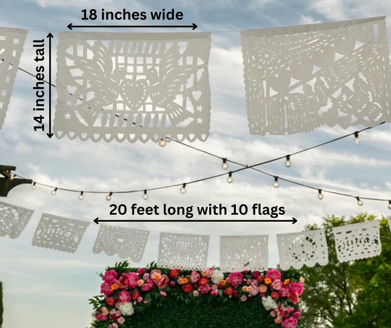 May include: White paper flags with intricate cut-out designs, strung together with string lights. The banner is 20 feet long with 10 flags, each measuring 18 inches wide and 14 inches tall.