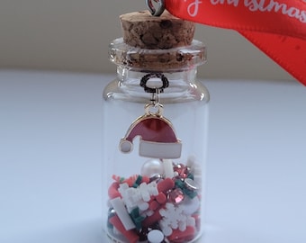 Christmas Tree Decoration, glass vial with Christmas charm and sprinkles, Santa's hat.