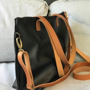 Black Leather bag with zip and brown leather straps. image 1