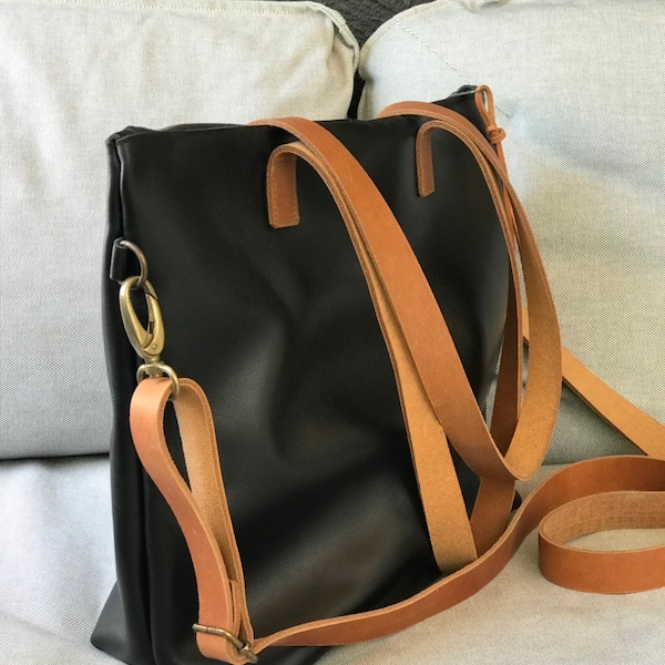 Black Leather bag with zip and brown leather straps.