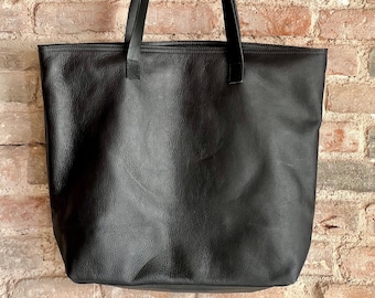 Oversized soft Black leather with zipper and inside lining with many pockets