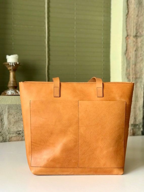 Oversized Cognac Leather tote bag with outside pockets. Cap Sa Sal