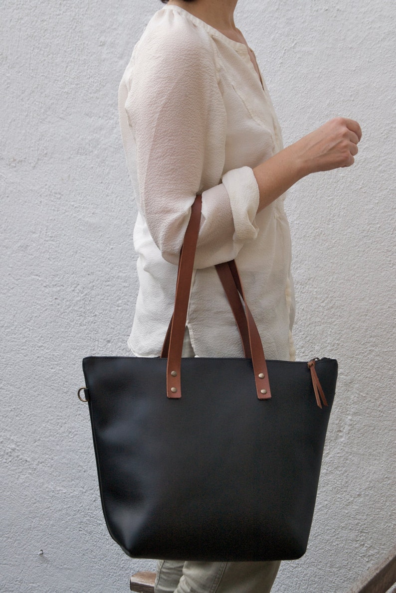 Black Leather bag with zip and brown leather straps. image 4