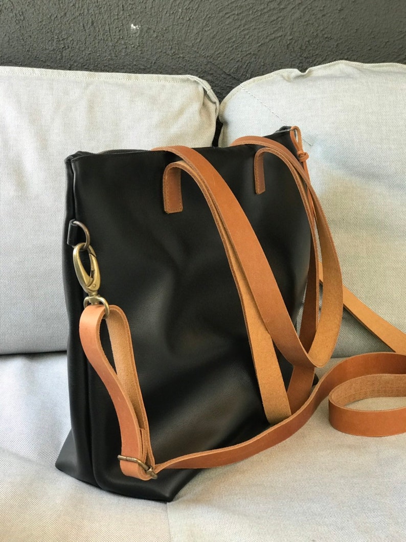 Black Leather bag with zip and brown leather straps. image 1