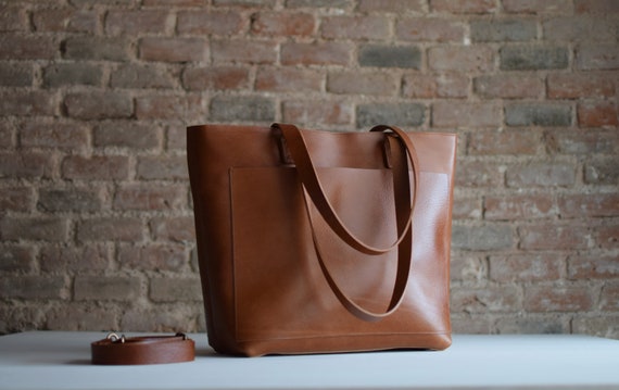 Tan / Cognac Leather tote bag with large outside pocket. The