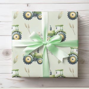 May include: Green and yellow tractor wrapping paper with a green ribbon. The paper features a repeating pattern of tractors, wheat stalks, and a rooster.
