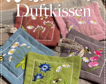May include: A collection of square, embroidered sachets in various colors, including red, pink, blue, green, and brown. Each sachet features floral and bee designs. The text "Wiesenblumen Duftkissen" is at the top.