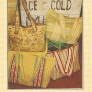 May include: Three tote bags made from fabric with different patterns. The bags are yellow, white, and brown with stripes and floral designs. The bags are sitting on a wooden chair with a sign that says "Ice Cold Milk".