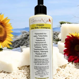 May include: A white bottle with a black pump dispenser labeled "Nature's Ego Organic Rice Milk + Fenugreek". The bottle lists ingredients including fermented rice water, shea butter, fenugreek, babassu oil, hempseed oil, sunflower lecithin, shikakai, amla, marshmallow root, brahmi, bhringraj, burdock root, cloves, and optiphen. The bottle is 8 oz (237 ml).