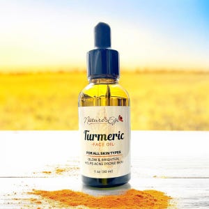 May include: A glass bottle of turmeric face oil with a dropper. The bottle is labelled "Nature's Ego Turmeric Face Oil" and says "For All Skin Types Glow & Brighten, Helps Acne Prone Skin 1 oz (30 ml)". There is a pile of turmeric powder in the foreground.
