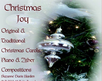 May include: A Christmas music CD cover featuring a silver ornament hanging from a Christmas tree with a white background. The text on the cover reads "Christmas Joy", "Original & Traditional Christmas Carols: Piano & Zither Compositions", "Suzanne Davis Harden", "© 2013 All Rights Reserved", and "PeacefulPrayerSongs.com".