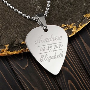 May include: Silver guitar pick necklace with the names Andrew and Elizabeth and the date 03-28-2022 engraved on it.