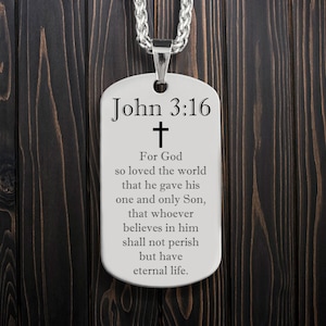 May include: Silver dog tag necklace with the text "John 3:16" and a cross. The text below the cross reads "For God so loved the world that he gave his one and only Son, that whoever believes in him shall not perish but have eternal life."