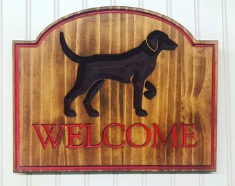 Welcome sign with brown dog