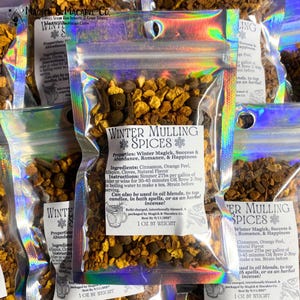 May include: Clear, iridescent pouches filled with winter mulling spices. Each pouch contains a blend of cinnamon, orange peel, allspice, and cloves. The label reads "Winter Mulling Spices" and includes instructions for use. The weight is 1 oz.