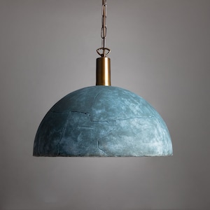 May include: A blue, cracked, dome-shaped pendant light fixture with a brass chain and a brass cap.