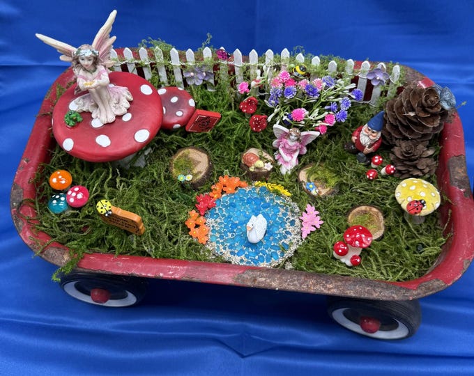 This little red wagon holds a magical fairy garden.